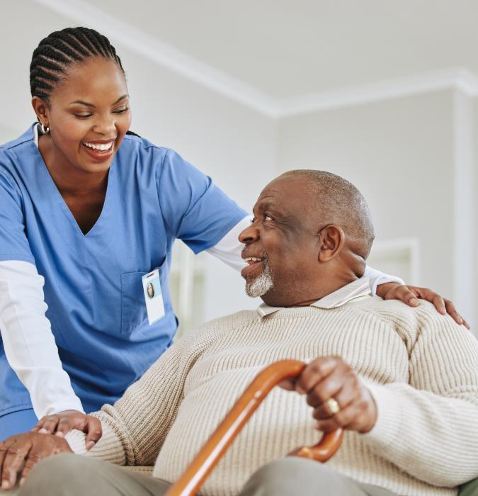 nurse helping man in home